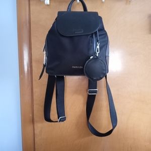 A Calvin Klein purse / book bag.